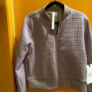 New. Tags on. Never worn. Silk inside. Dark lavender in color.